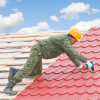 Roofer installing metal roof