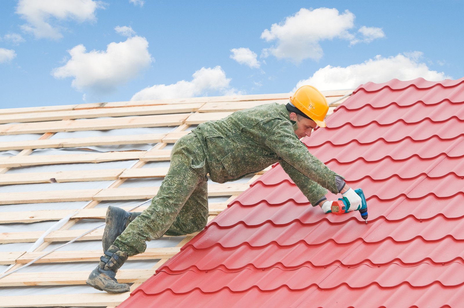 Roofer installing metal roof